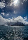Dramatic clouds surround the sharp peaks of Antarctic mountains Royalty Free Stock Photo