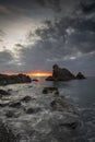 Dramatic clouds at sunrise hovering over sea