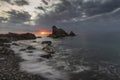 Dramatic clouds at sunrise hovering over sea