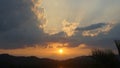 Dramatic clouds during sunset with clouds light rays over the mountains and river with reflections, Thailand Royalty Free Stock Photo