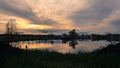 Dramatic clouds and sunset sky over the lake. Royalty Free Stock Photo