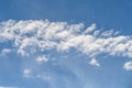 Dramatic cloudscape with fast moving white clouds against a blue sky, as a nature background Royalty Free Stock Photo