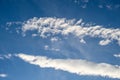 Dramatic cloudscape with fast moving white clouds against a blue sky, as a nature background Royalty Free Stock Photo