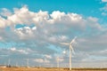 Dramatic cloudscape gather over wind energy field with many turbines