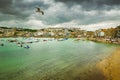 Dramatic cloudscape and scenic panorama of beach of St Ives coastal town, Cornwall, England