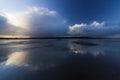 Dramatic cloudscape and skyscape reflection on the water pooled surface of Red Wharf Bay, Isle of Anglesey