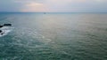 Dramatic cloudy seaside panorama with gray gloomy sky over dark ocean aerial. Royalty Free Stock Photo