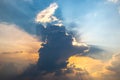 Dramatic cloudy sky with golden sunlight breaking through at sunset. A mix of dark storm clouds and soft illuminated areas creates Royalty Free Stock Photo
