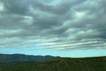 Dramatic cloudy sky with light horizon over mountains Royalty Free Stock Photo