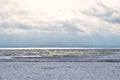 Winter coastal landscape with ice and snow on beach Royalty Free Stock Photo