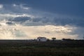 Dramatic cloudy stormy sky over two houses seaside