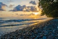 Dramatic coast with rocky volcanic beach, green tree, waves and amazing sunset, Limbe, Cameroon