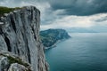 Dramatic Coastal Cliffside and Ocean Vista Under a Cloudy Sky A breathtaking view of a rugged coastline with steep cliffs Royalty Free Stock Photo