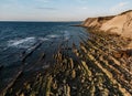 Dramatic coastal rock formations with layered striations Royalty Free Stock Photo