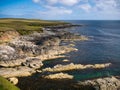 Dramatic coastal scenery showing inclined and eroded rock strata around the Ness of Queyon, near Otters Wick on Yell, Shetland