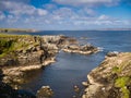 Dramatic coastal scenery showing inclined and eroded rock strata around the Ness of Queyon, near Otters Wick on Yell, Shetland, UK