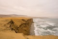 Dramatic coastline with intense colors in the desert of Paracas National Reserve Royalty Free Stock Photo