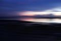 Dramatic and colorful blue sunrise sky over the sea horizon. Blue sky with smooth motion clouds and the wave water reflection Royalty Free Stock Photo