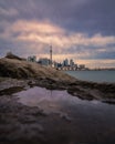 Dramatic colorful clouds at sunset behind the Toronto skyline, reflecting in water Royalty Free Stock Photo