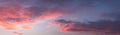 Dramatic colorful dawn/dusk sky, with dark clouds, panorama background. Royalty Free Stock Photo