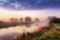 Dramatic colorful scenery. Dawn on riverbank. Misty morning on river Royalty Free Stock Photo