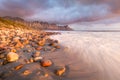 Stormy seascape with water rushing onto the beach.