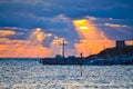 Sun rays through dark clouds over cross at pier Nessebar coast Bulgaria Royalty Free Stock Photo