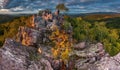 Dramatic, colorful sunset in the autumn landscape. Bizarre, colorful rocks, illuminated hills and trees, beautiful sky Royalty Free Stock Photo