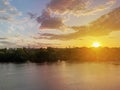Dramatic colorful sunset over Dnipro river in Kiev, Ukraine. Historical sights of Ukraine. Beautiful scenic view of Kyiv. Sunset Royalty Free Stock Photo