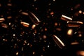 Falling bullets border over black background with light Royalty Free Stock Photo