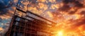 Dramatic Construction Site at Sunset with Scaffolding and Vibrant Sky Backdrop Royalty Free Stock Photo