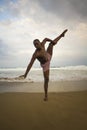 Dramatic contemporary dance choreographer doing ballet beach workout, young attractive and athletic afro black American man