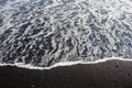 Dramatic contrast between the white sea foam and a black volcanic sand beach as seen from the South Coast in Iceland Royalty Free Stock Photo