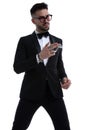 Dramatic cool man in tuxedo making gun gesture to side Royalty Free Stock Photo