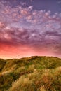 Dramatic copyspace landscape of purple sky and sunset on west coast of Jutland in Loekken, Denmark. Sun setting on the