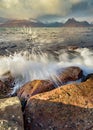 Crashing waves on Inner Hebrides coastline with dramatic Winter stormy rain clouds in the sky. Taken at Elgol on the Isle of Skye. Royalty Free Stock Photo