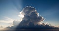 Dramatic Cumulus Cloud Formation with Sunbeams in Clear Blue Sky Royalty Free Stock Photo