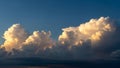 Dramatic Cumulus Clouds Illuminated by Golden Sunset Light Against a Deep Blue Sky Keywords: clouds, cumulus Royalty Free Stock Photo