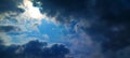 Dramatic dark clouds with a bright sunlight burst through the blue sky. A perfect stormy contrast.? Royalty Free Stock Photo