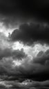 Dramatic dark clouds fill the sky, creating a moody monochrome cloudscape with soft light Royalty Free Stock Photo
