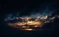 Dramatic dark evening sky landscape with moody clouds and golden sunlight Royalty Free Stock Photo