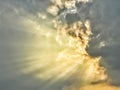 Dramatic dark and golden storm clouds with sunbeams