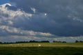 Dramatic dark grey sky over the dike and pastures at Langwarder Groden Germany Royalty Free Stock Photo