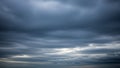 Dramatic dark grey storm clouds gathering in the sky with streaks of light breaking through Keywords: sky, clouds Royalty Free Stock Photo