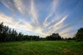 dramatic dark red clouds in sunset over countryside fields and forests Royalty Free Stock Photo