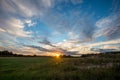 dramatic dark red clouds in sunset over countryside fields and forests Royalty Free Stock Photo