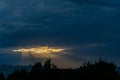 dramatic dark red clouds in sunset over countryside fields and forests Royalty Free Stock Photo