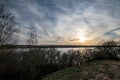 dramatic dark red clouds in sunset over countryside fields and forests Royalty Free Stock Photo