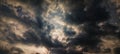 Dramatic dark storm clouds with a glimpse of light breaking through the center. Moody sky atmosphere Royalty Free Stock Photo