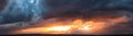 Dramatic dark sunset. Panorama of dark rain clouds in the evening Royalty Free Stock Photo